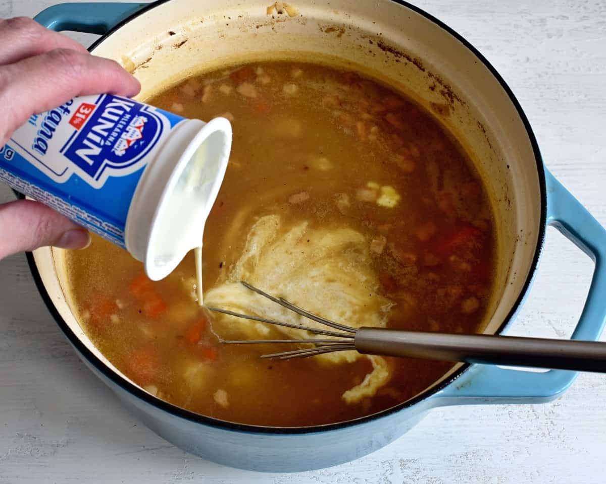 adding cream to sauce