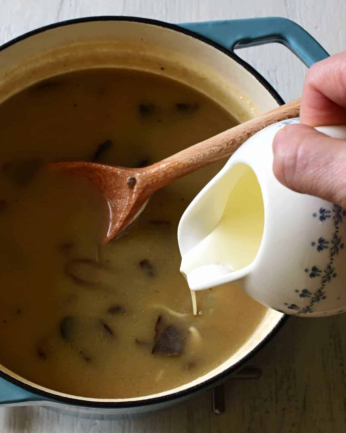adding cream to kulajda soup