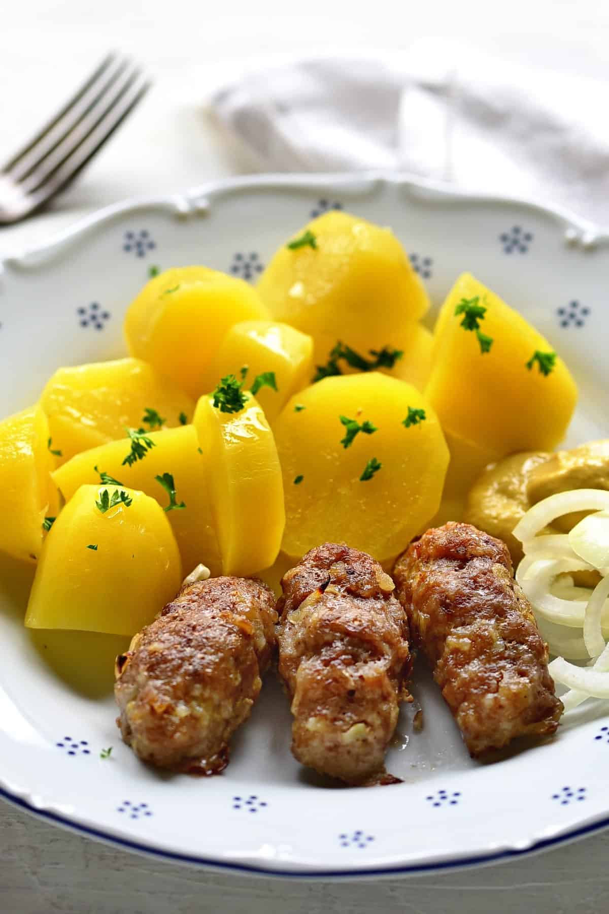 cevabcici served with potatoes