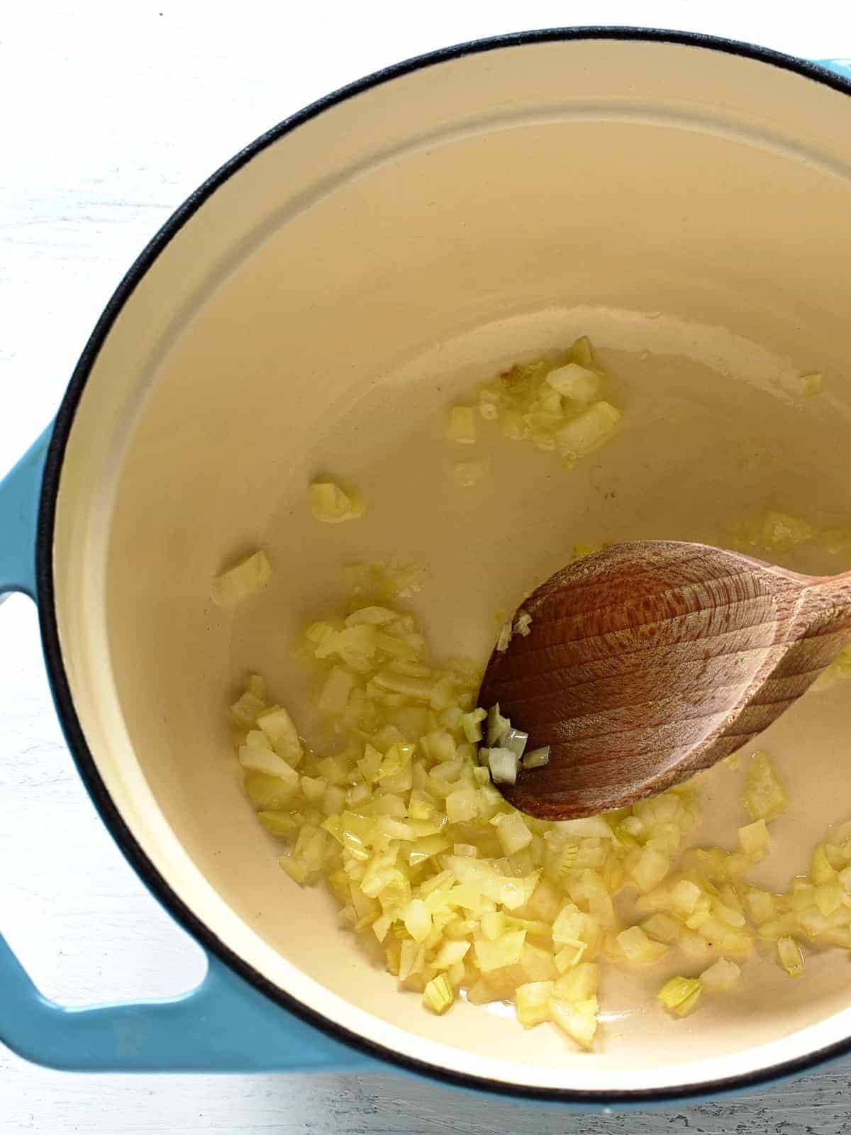 frying onion in a pot