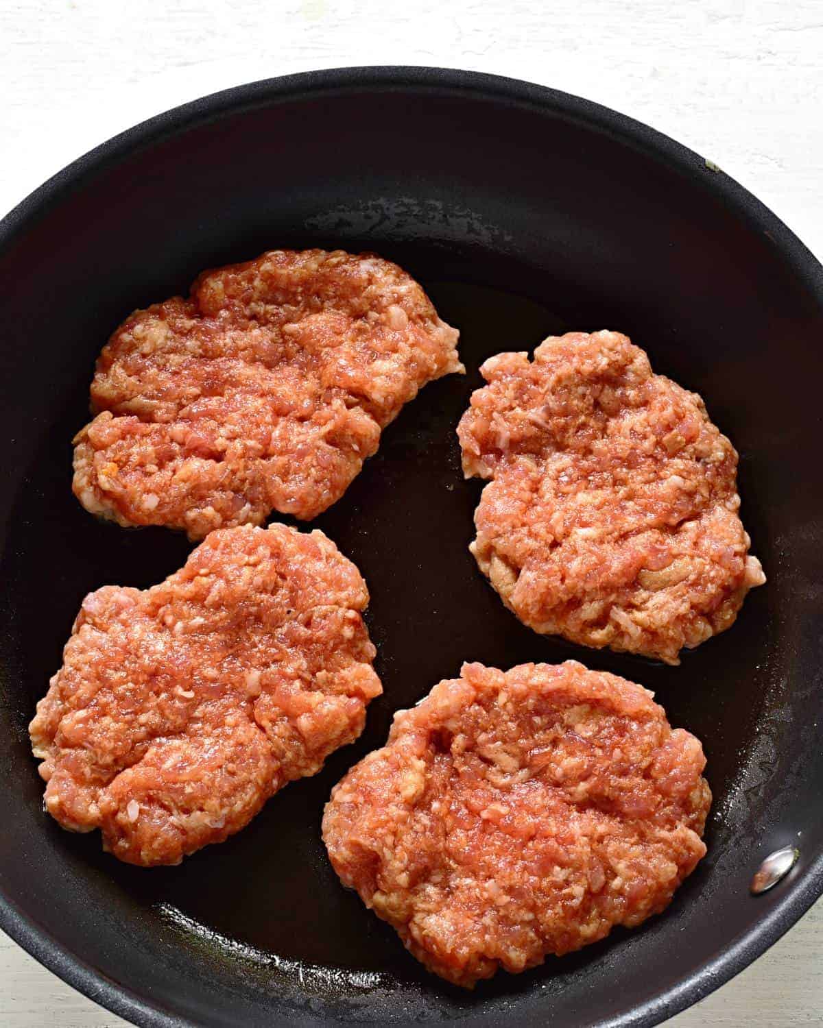 frying pork patties in a pan