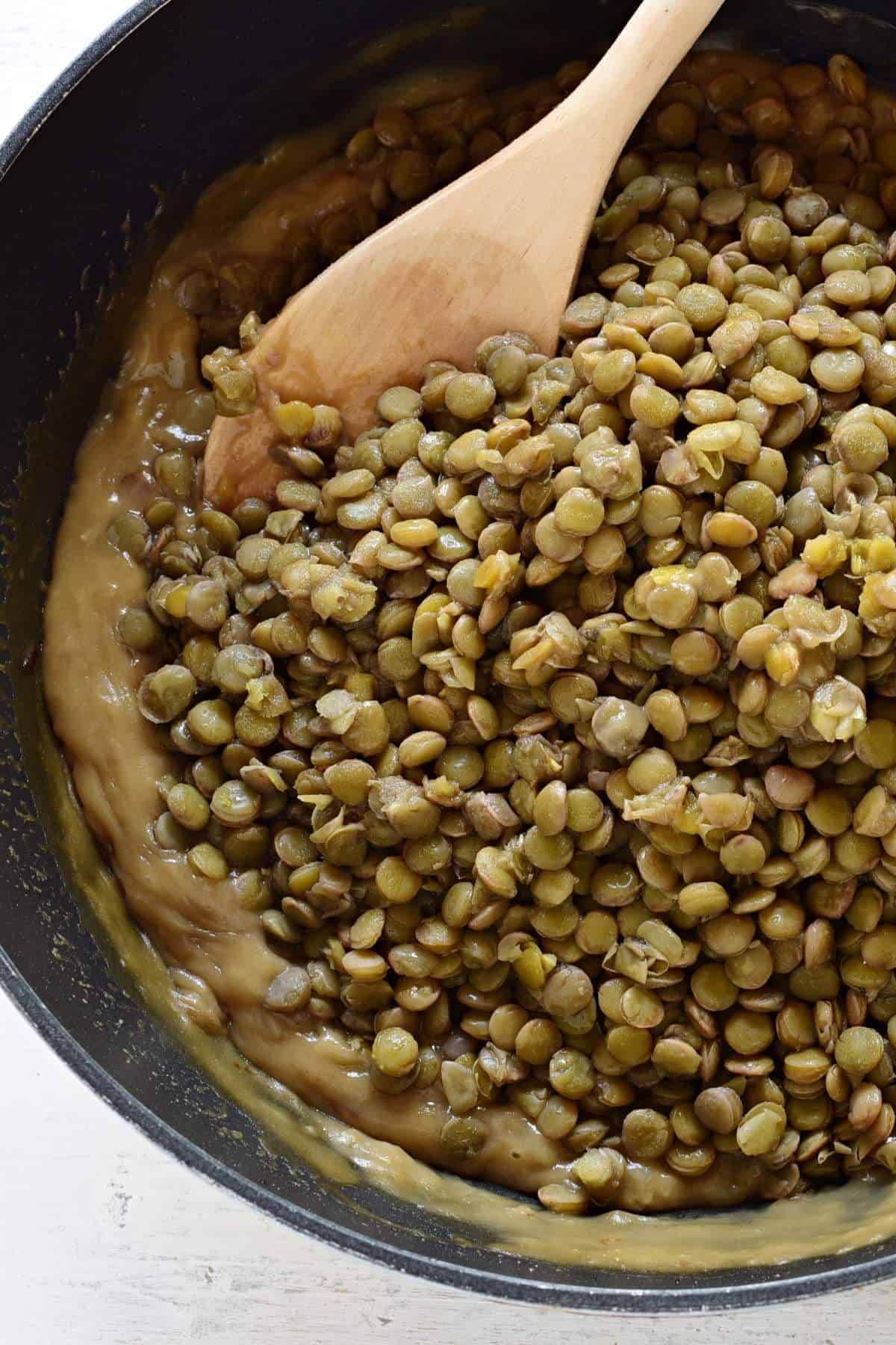 Adding lentils to the onion roux.