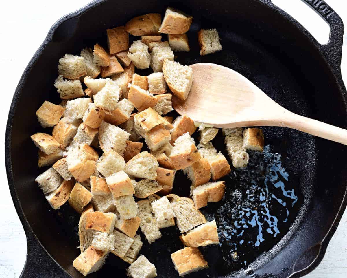 Making bread croutons in a pan.