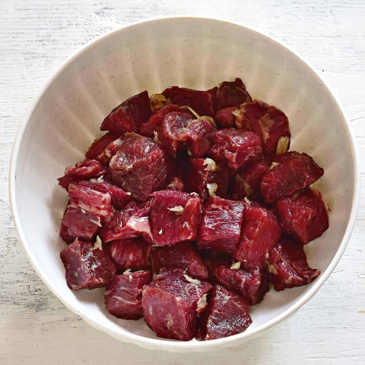 Beef cubes mixed with garlic.