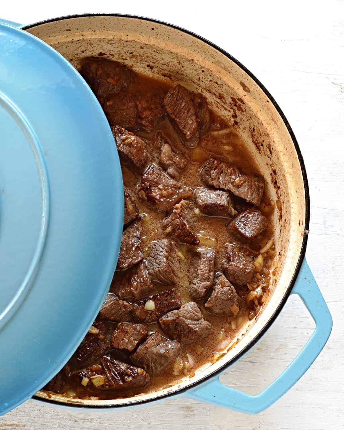 Slowly cooking beef cube in a water.