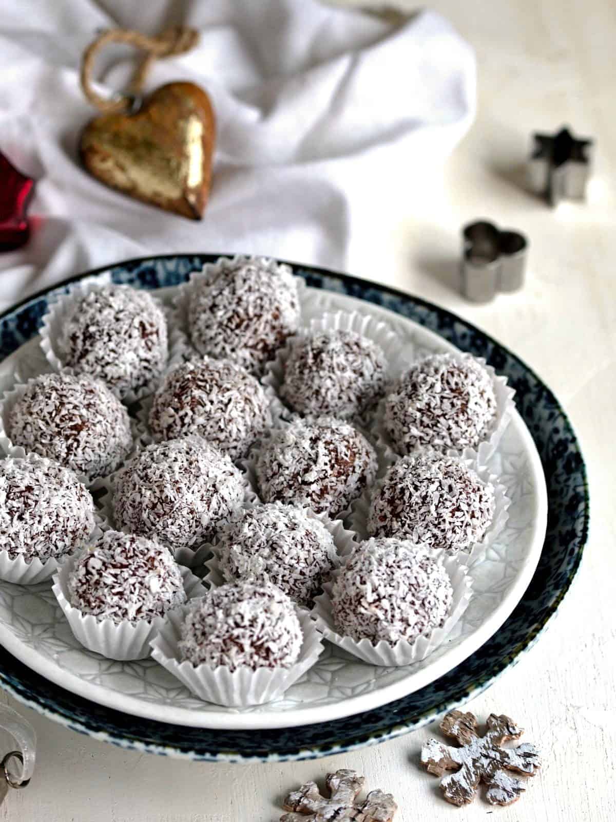 Coconut balls dark coated in shredded coconut.