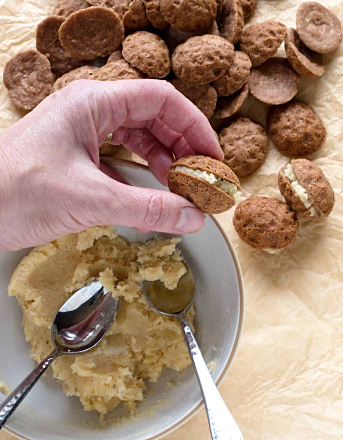 Filling nut cookies.