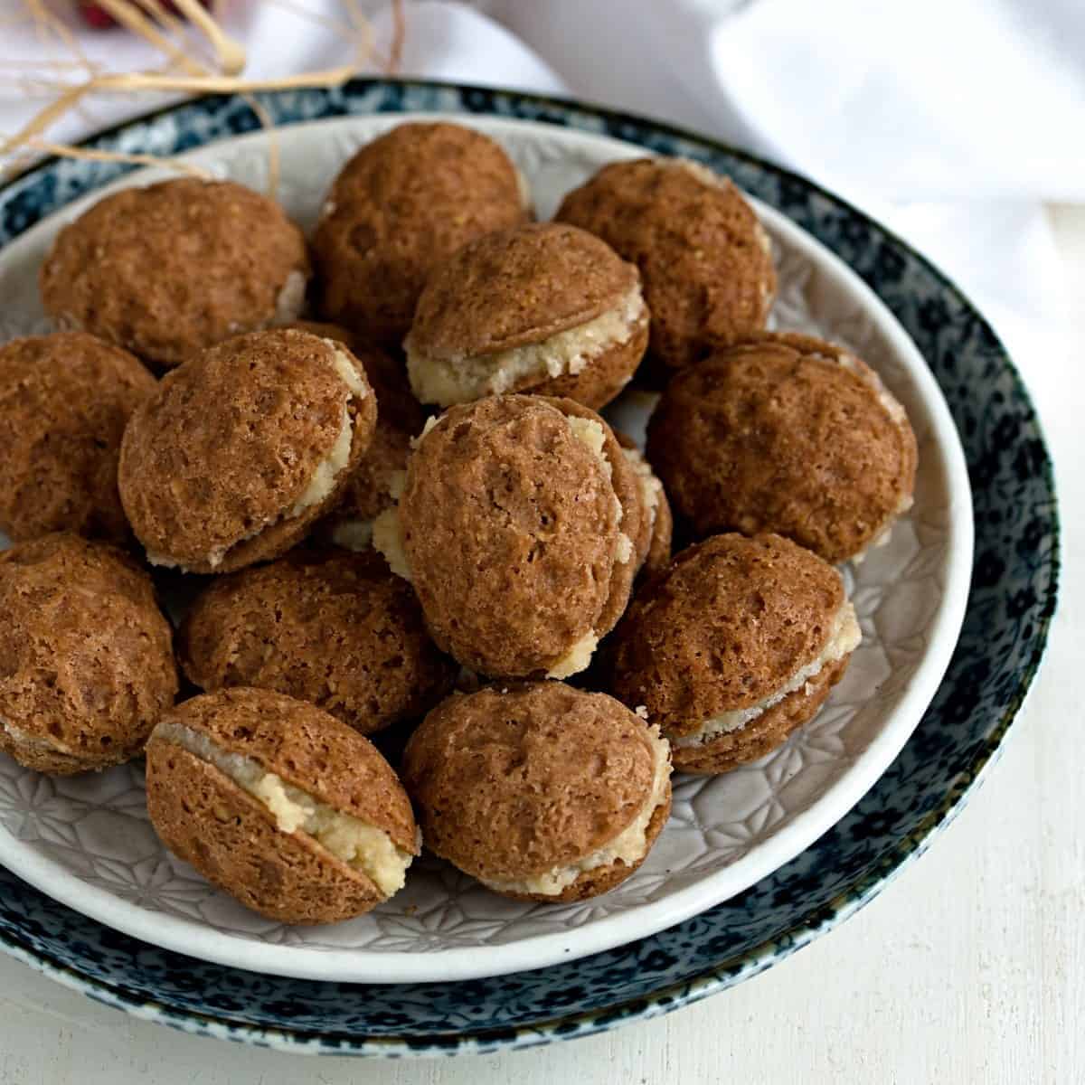 Buttercream filled nut cookies.