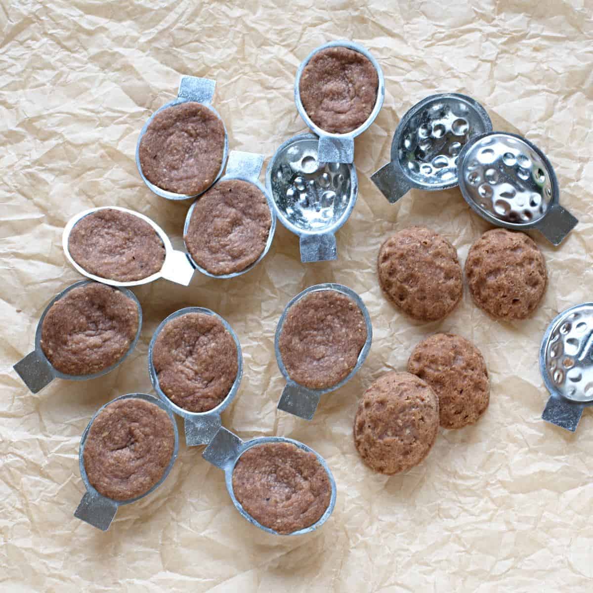 Baked nut cookies in steel molds.