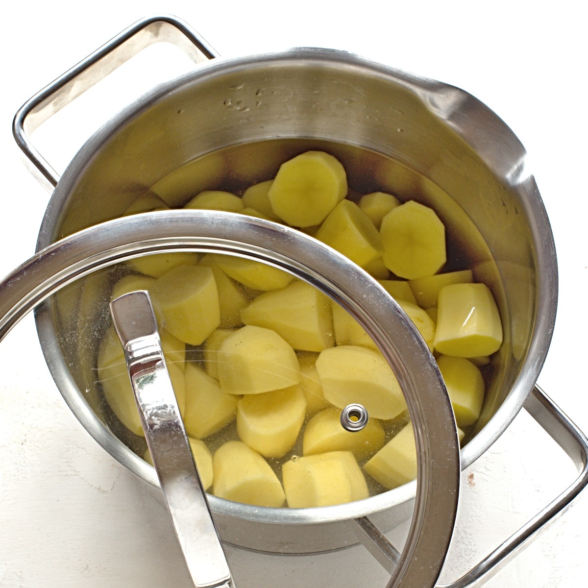 A pot with peeled potato chunks. 