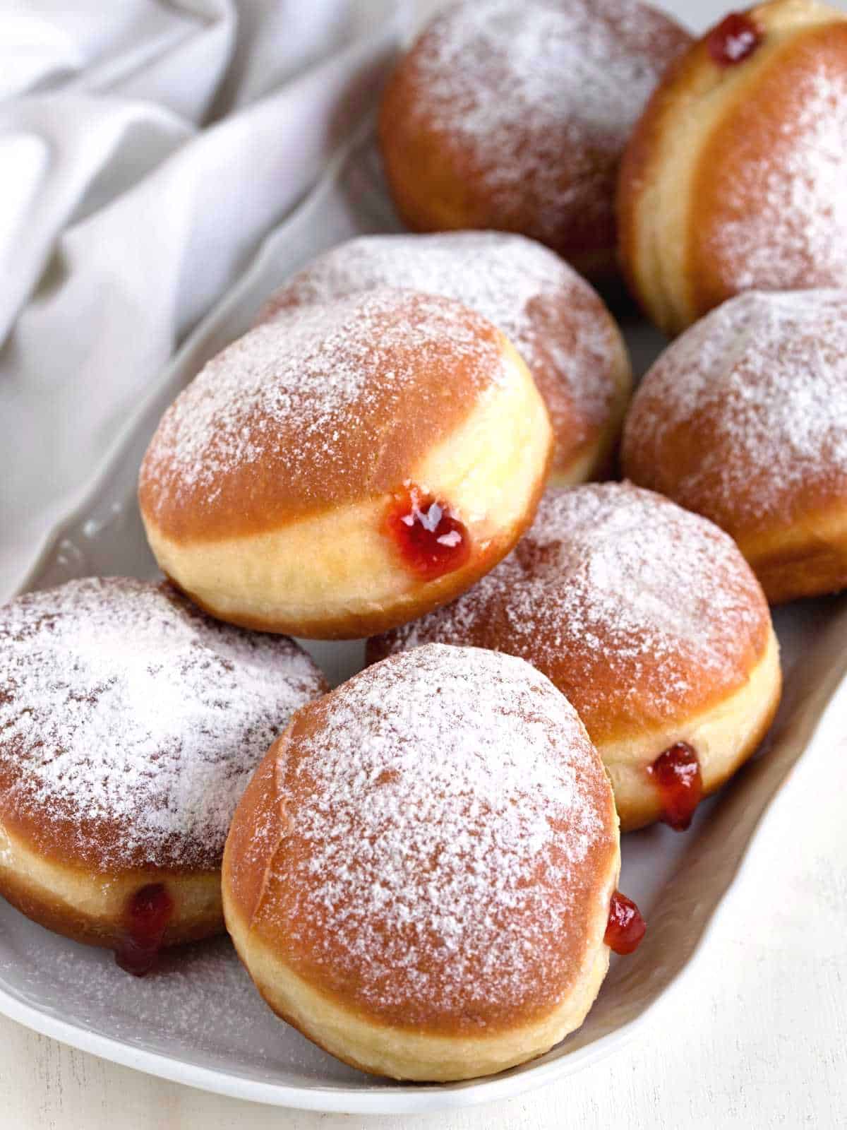 Czech koblihy dusted with icing sugar and filled with jam.