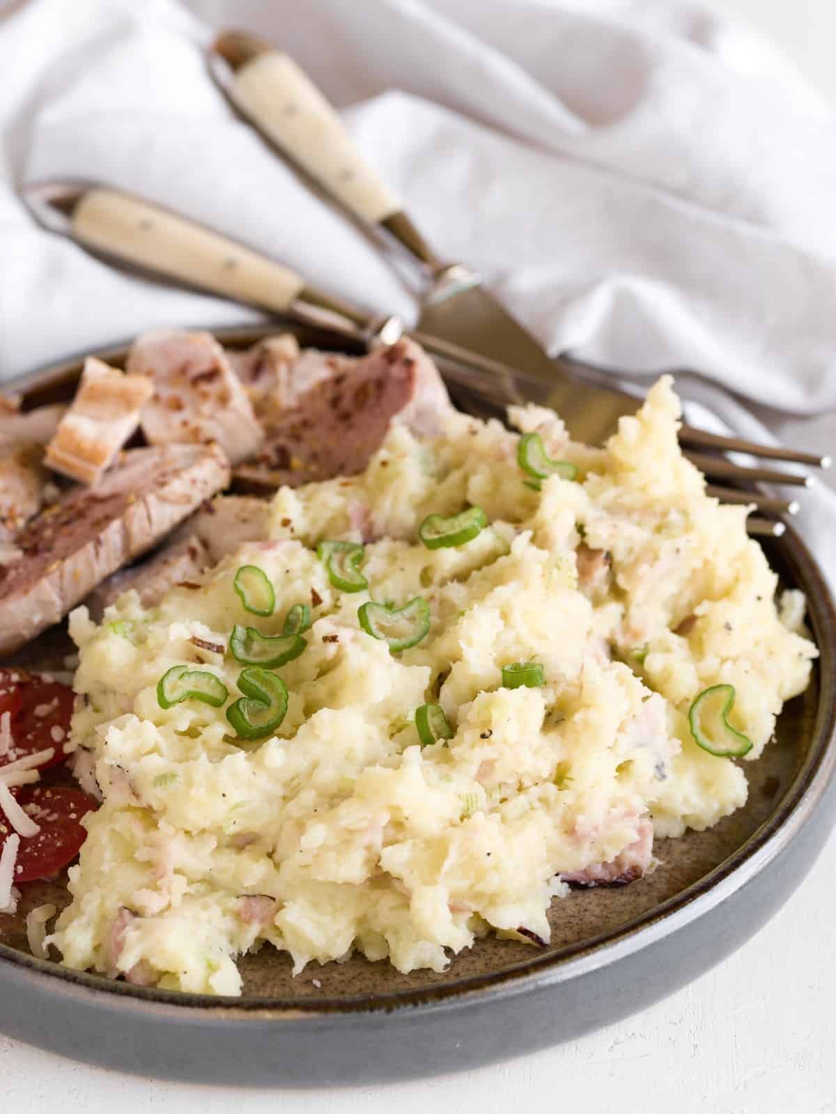 Chunky mashed potatoes served with meat.