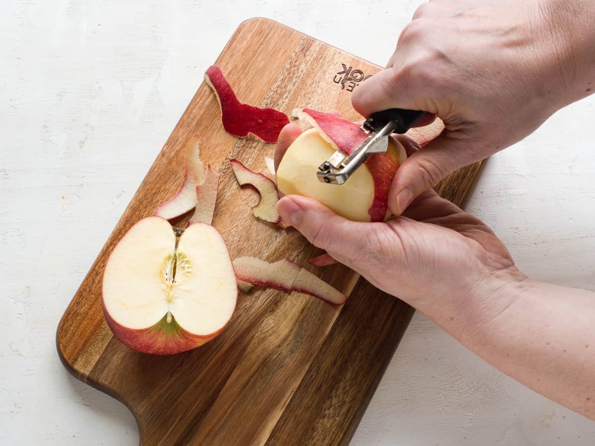 Cleaning apples, peeling their skins.