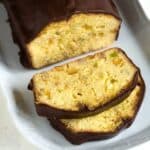 Sliced fruit bread with candied fruits and chocolate icing.