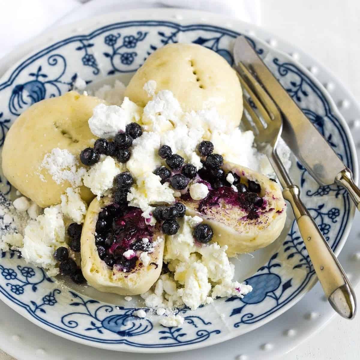 Czech blueberry-filled dumplings served with farmers cheese.