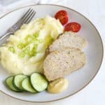 Pork meatloaf served with potato puree and vegetables.