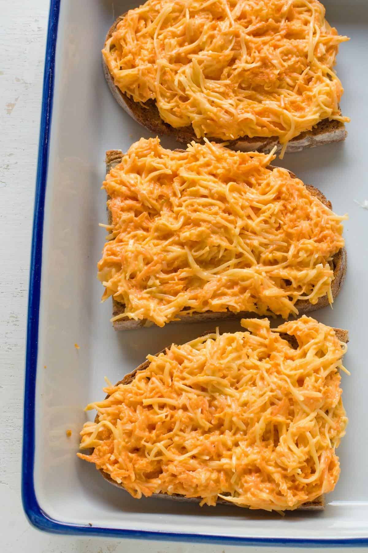 Slices of bread topped with carrot-cheese spread.