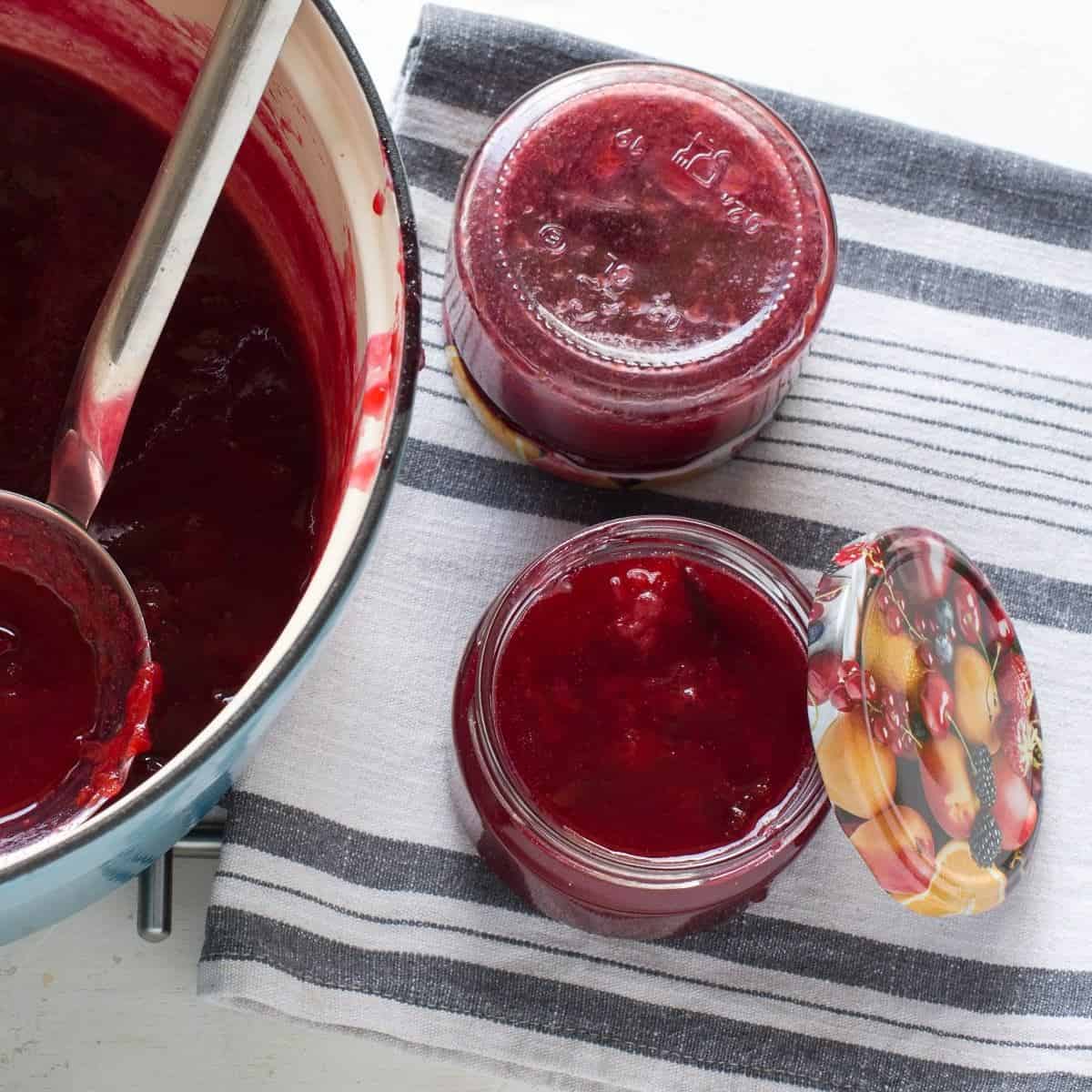 Filling plum compote in jars.