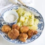 Fried cauliflower served with boiled potatoes and a cup of tartar sauce.