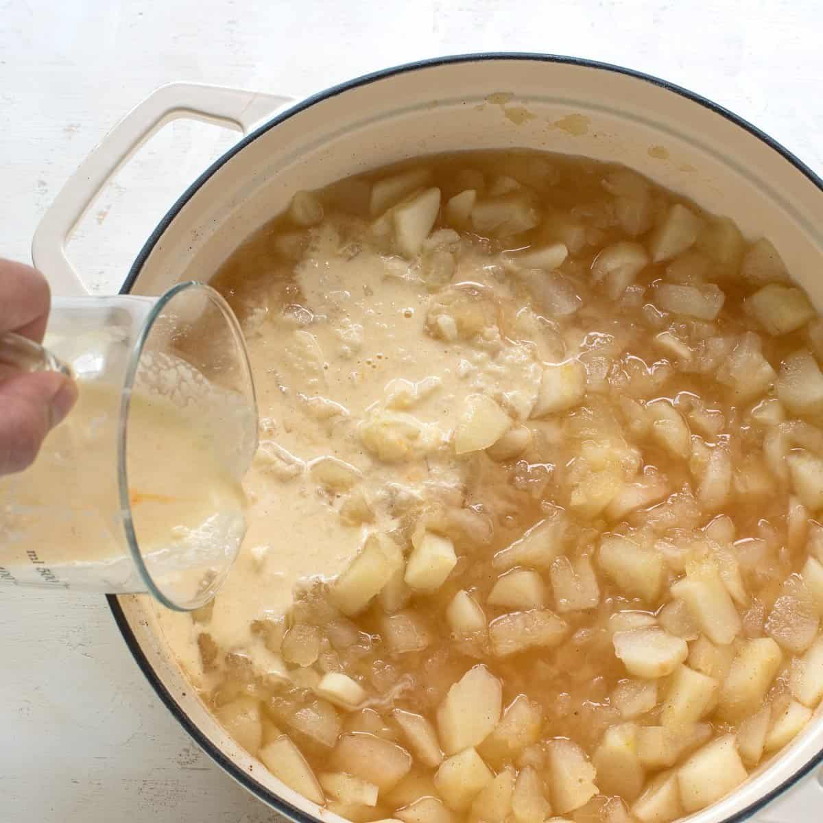 Making apple jelly, thickening pieces of cooked apples with cornstarch mixture.