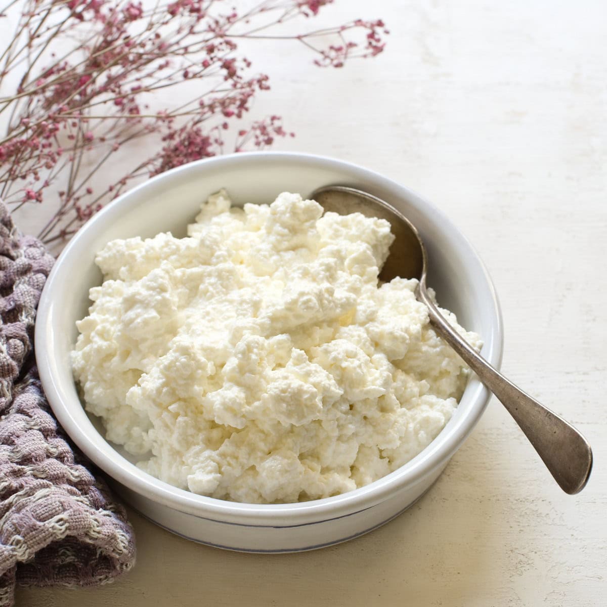 Czech homemade tvaroh cheese in a small round bowl.