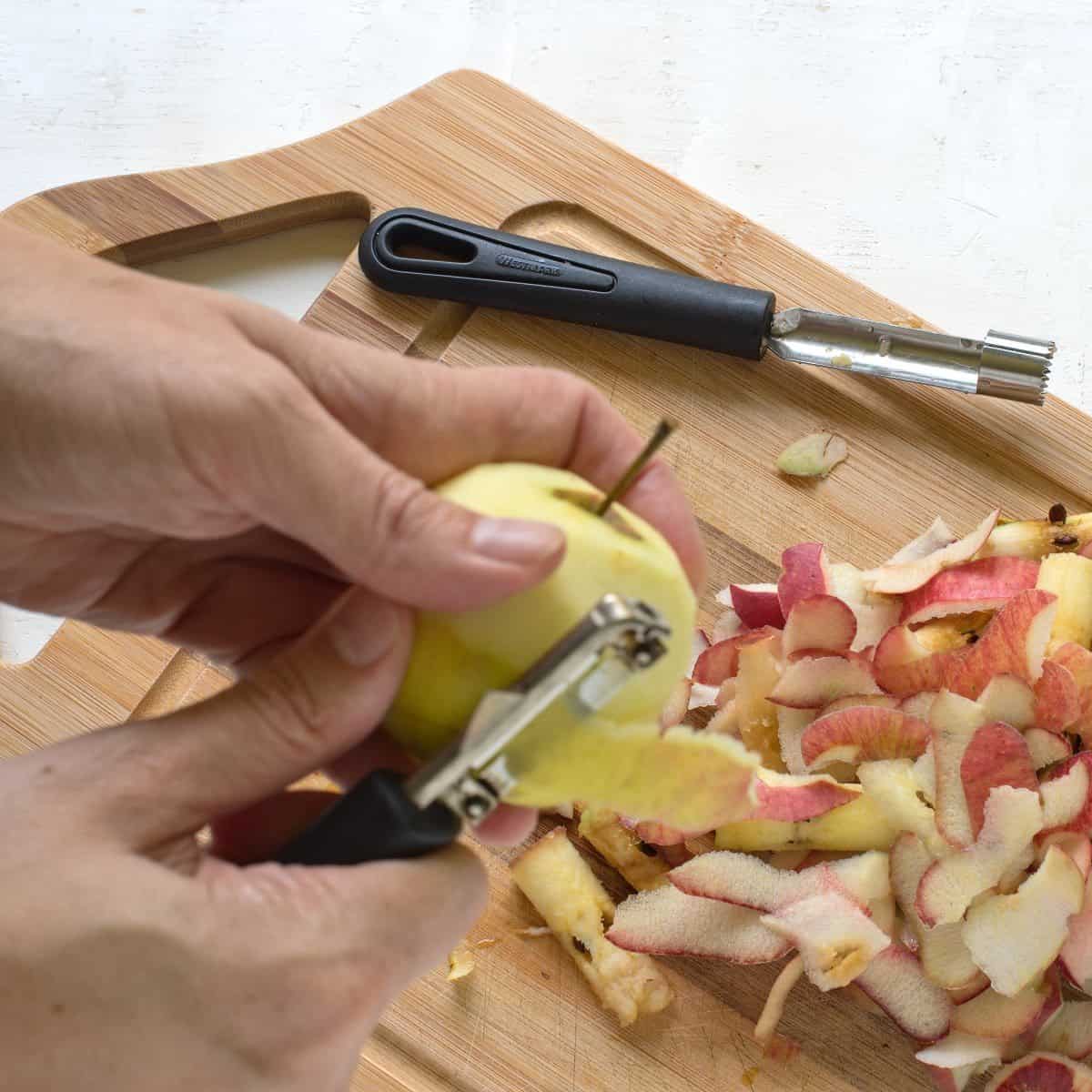 Peeling apples with a peeler.