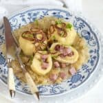 Czech stuffed potato dumplings with smoked meat, served with sauerkraut.