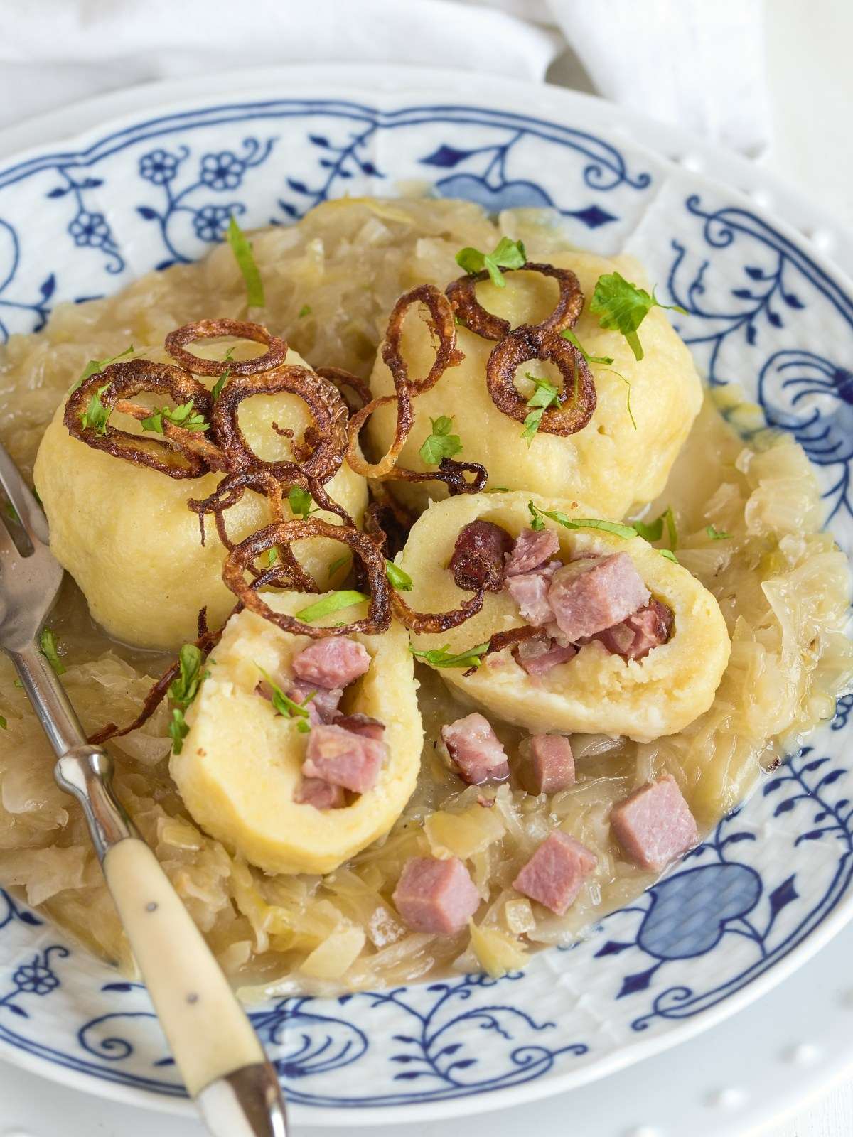 Czech stuffed potato dumplings with smoked meat, served with sauerkraut.