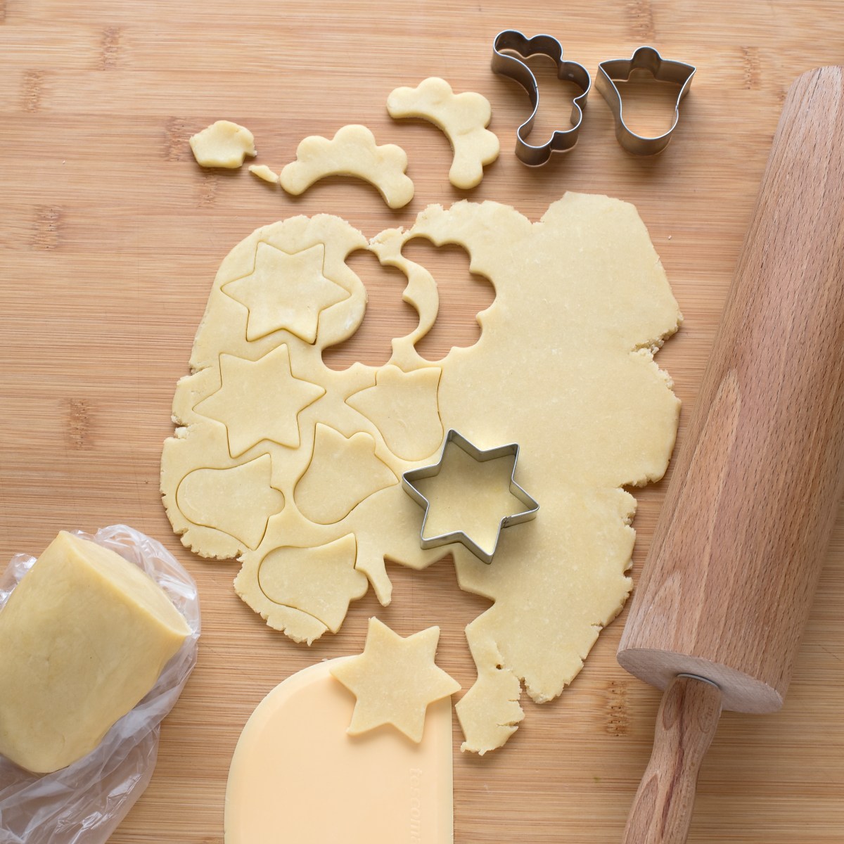 Cutting out different shapes of heavy cream cookies.