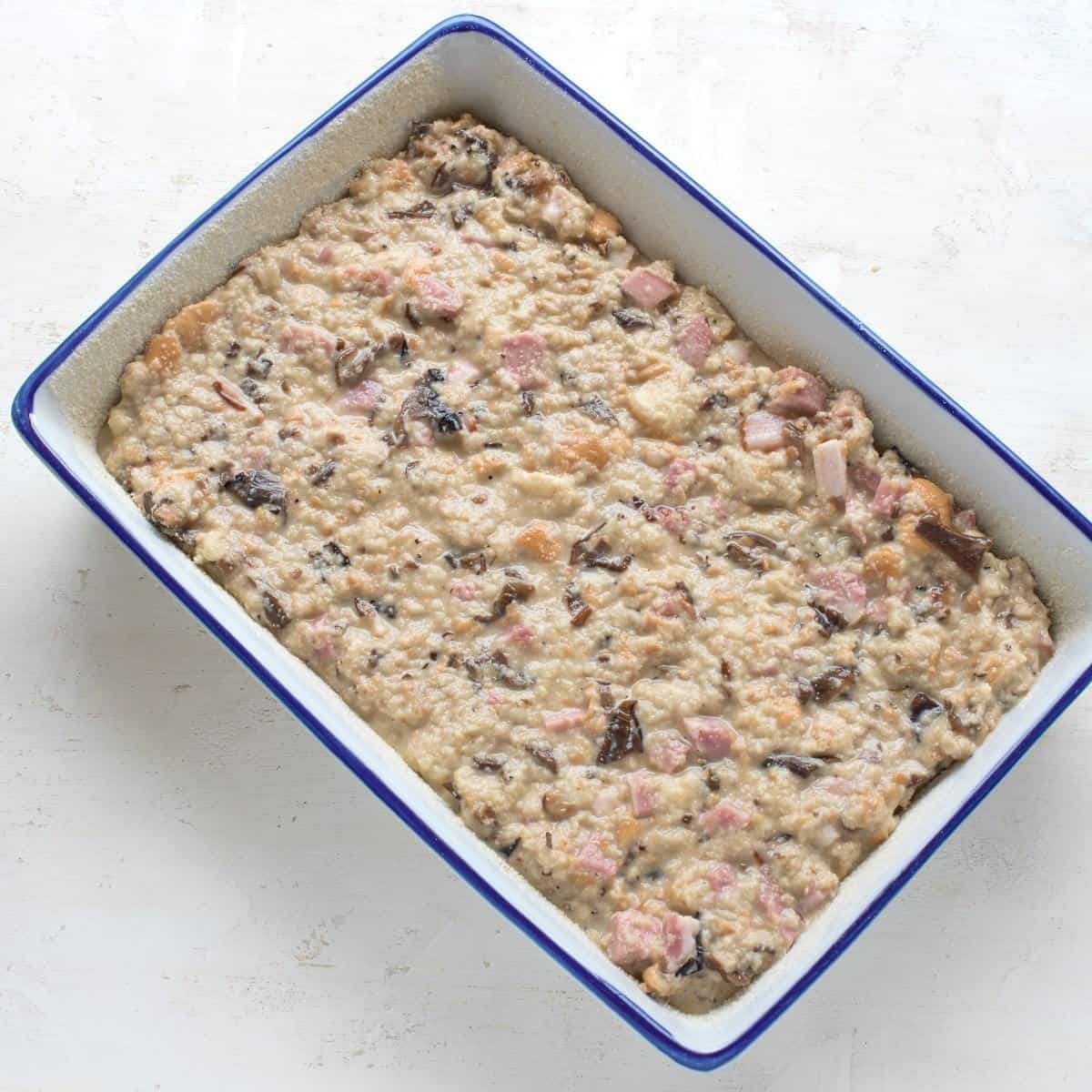 Muhroom bread pudding in a baking dish, before putting into the oven.