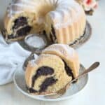 Yeast bundt cake with poppy seed filling, served on a plate with a dessert fork.