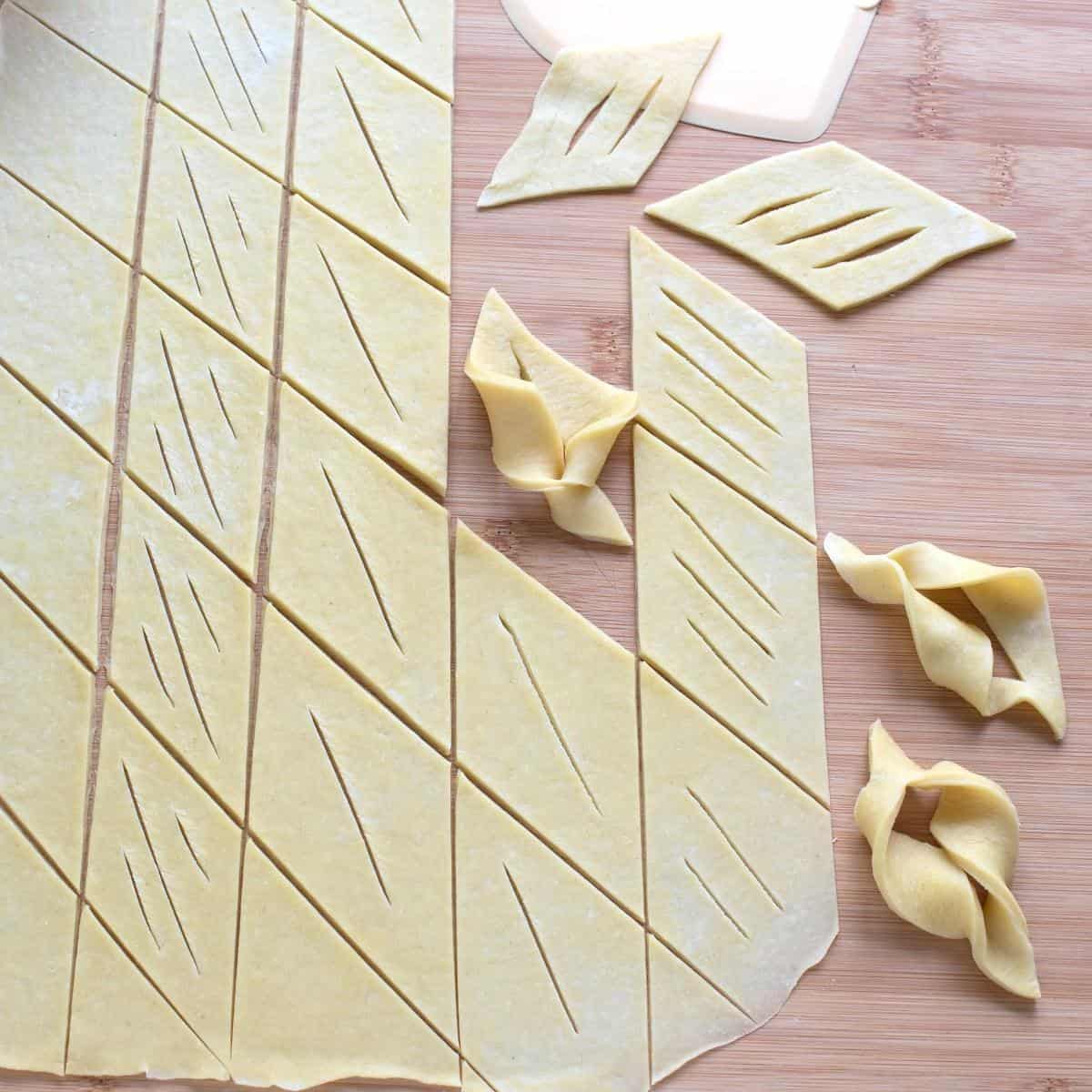 Cutting and forming various shapes of thinly rolled dough for bozi milosti.