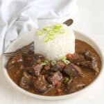 Sautéed pork liver with sauce, served with rice.