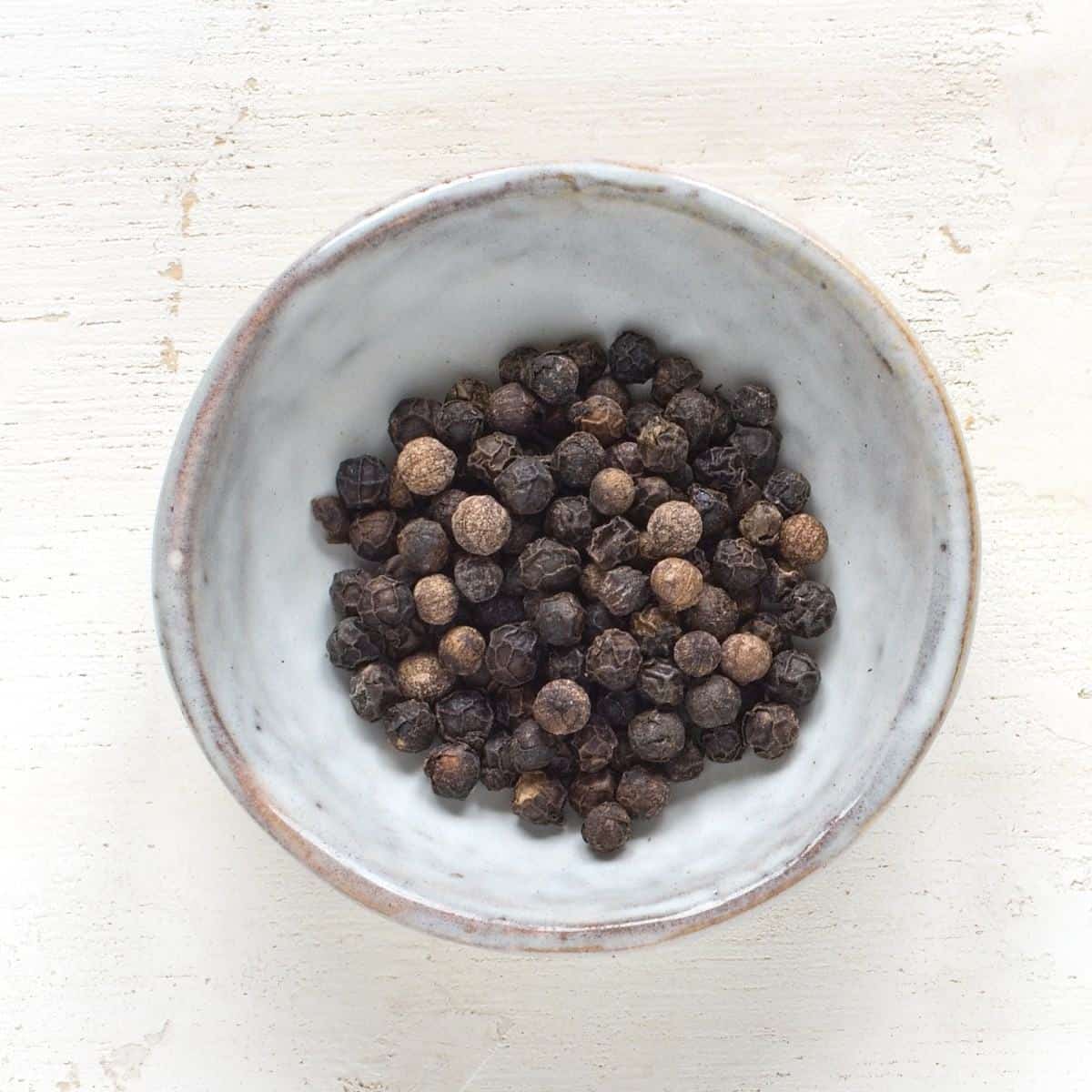 Black pepper in a small grey bowl.