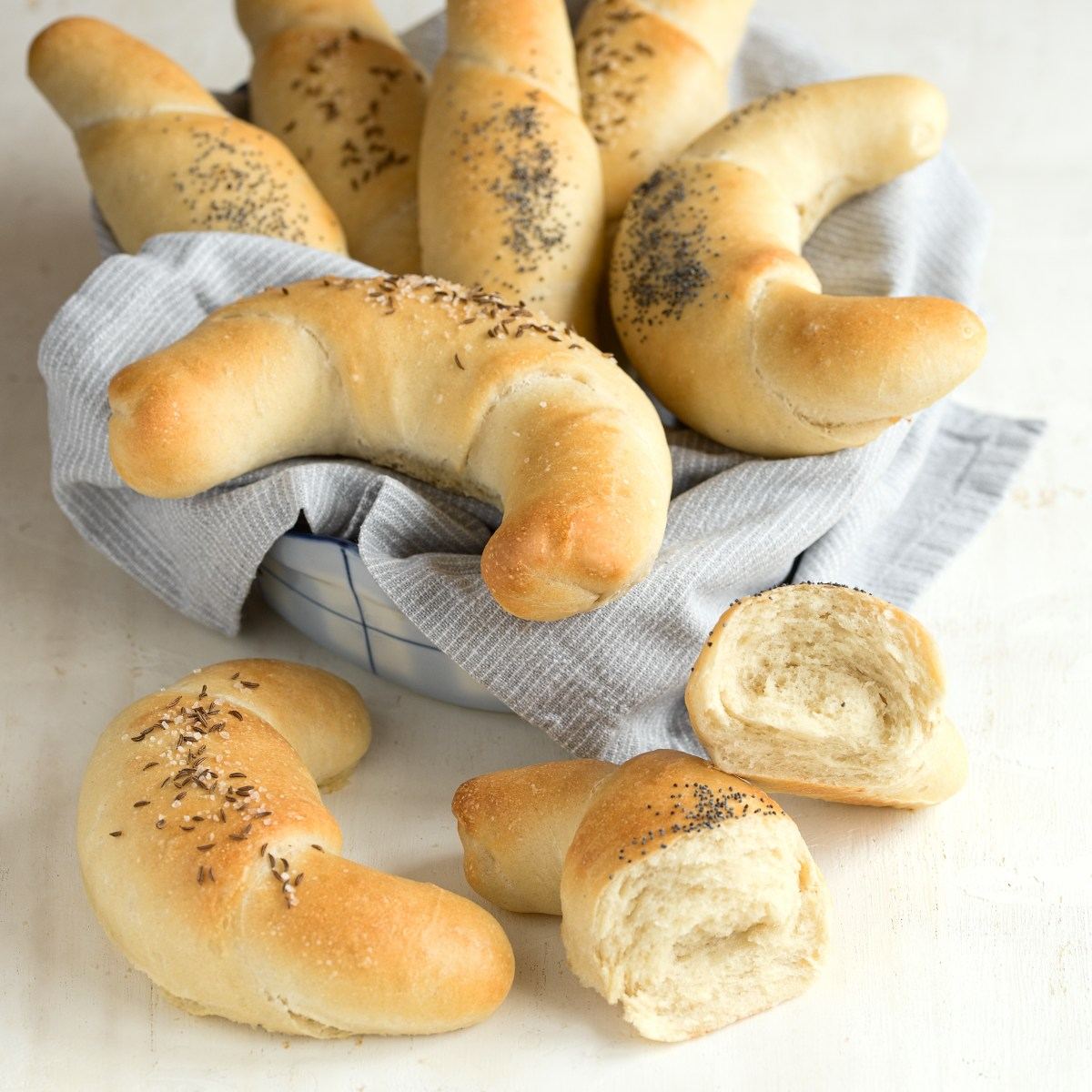 Czech rohliky bread rolls served on a kitchen towel.