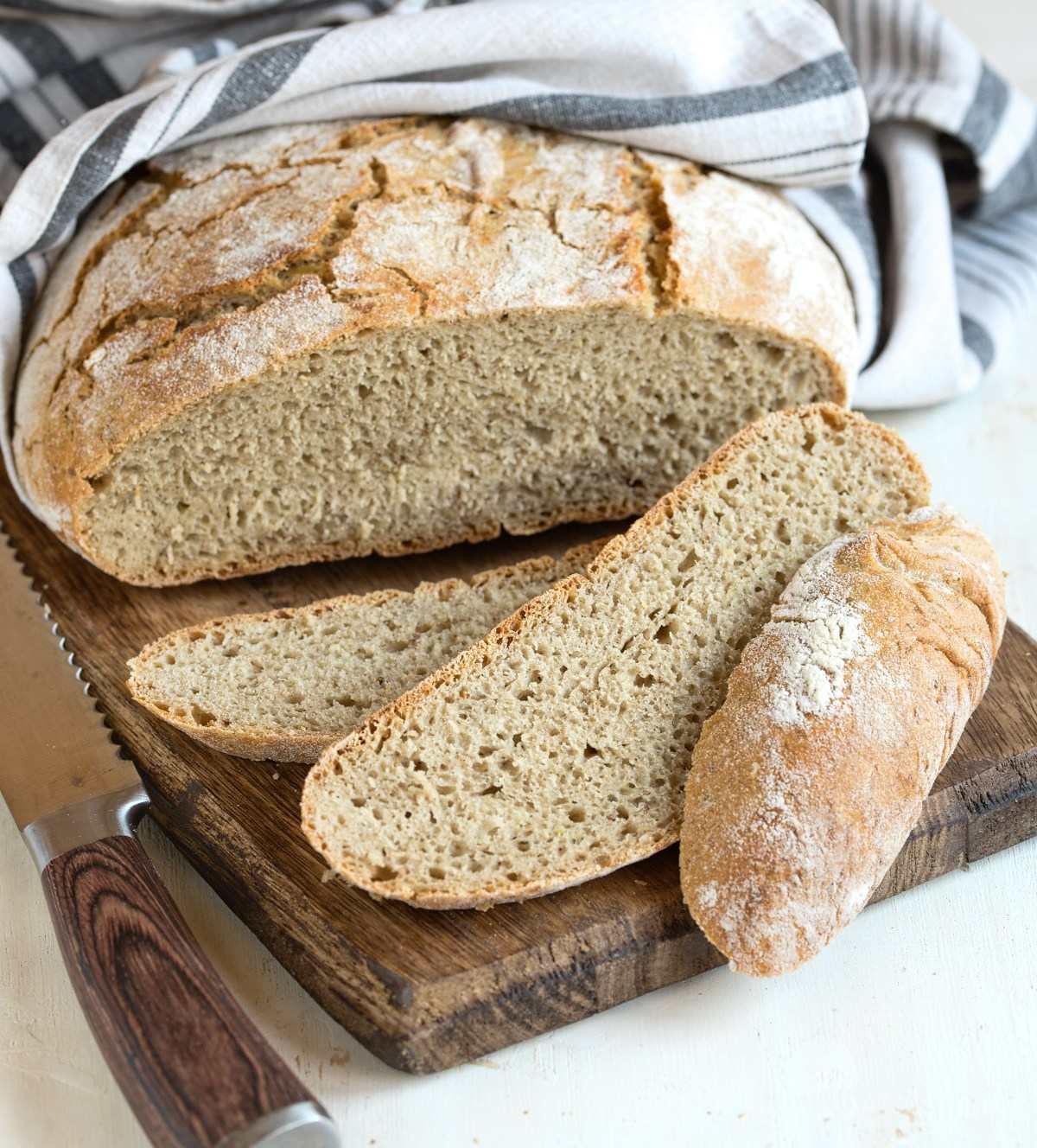 Sliced rye bread on wooded board.