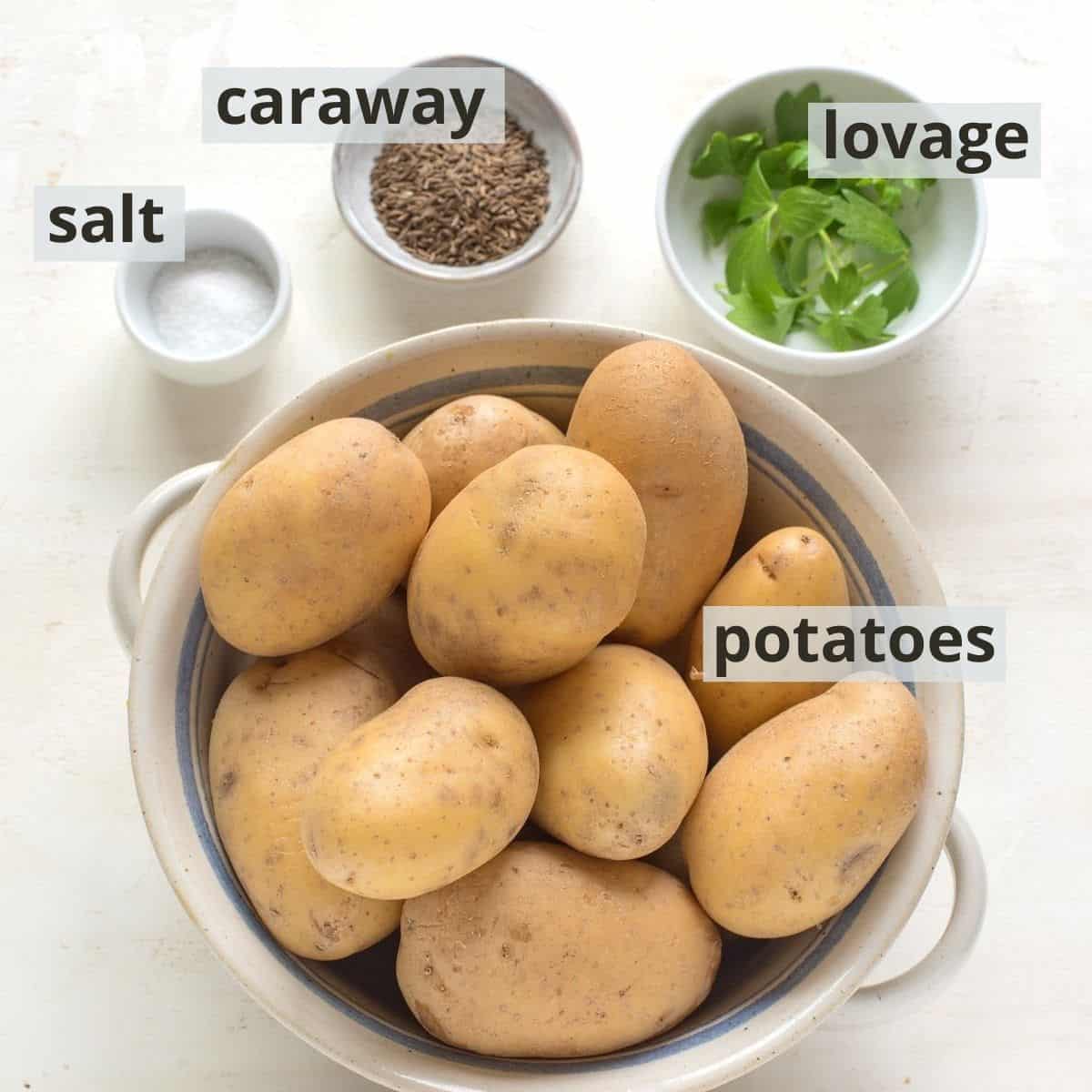 Ingredients for boiled potatoes seasoned with salt, caraway and lovage, with captions.