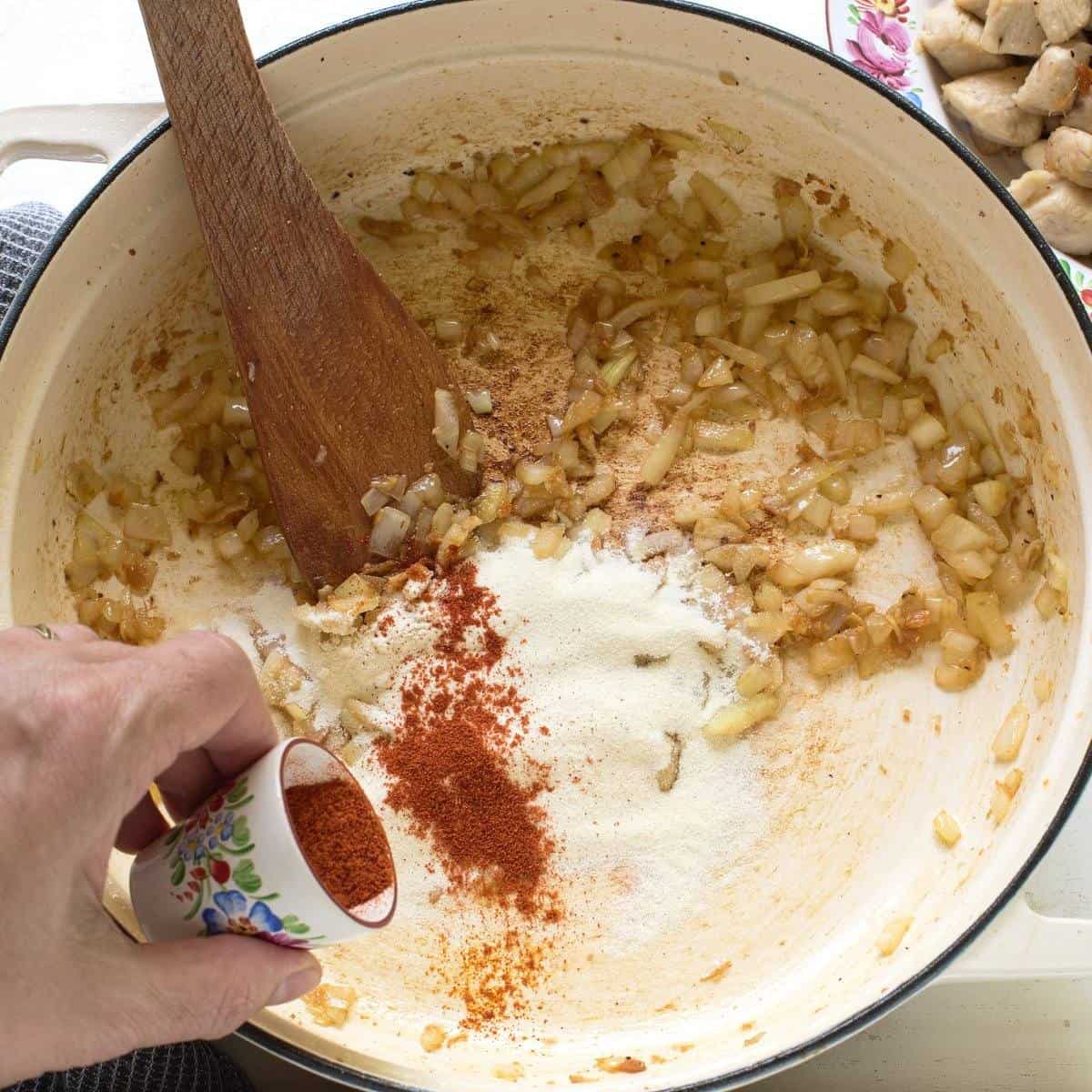 Making chicken paprikash gravy - fried onions, flour and sweet paprika powder.