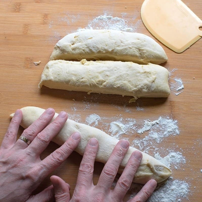 Rolling a strand of raised dough to make bobalki.