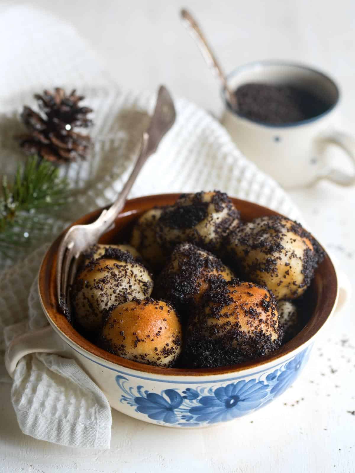 Slovak sweet bobalki balls sprinkled with poppy seeds, served in a bowl.