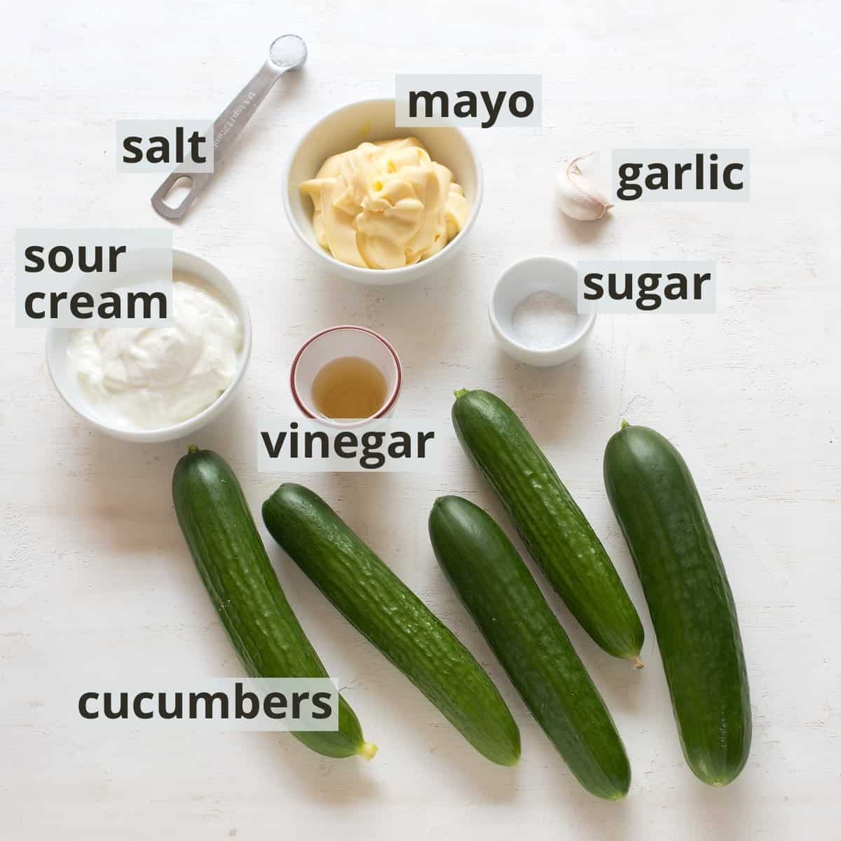 Creamy cucumber salad ingredients, inclusive captions.