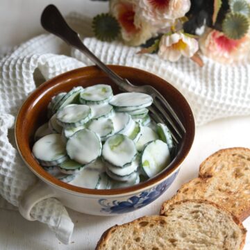 Creamy cucumber salad with garlic served in a bowl.