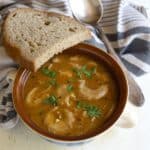 Czech oyster mushroom soup served with a slice of rye bread.