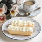 Czech coffin cookies filled with whipped cream, served on a small plate with blue dots.