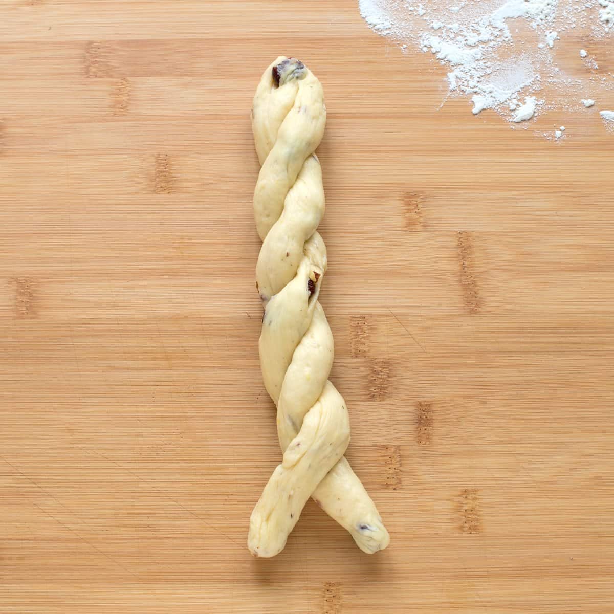 Two twisted strands of yeast dough.