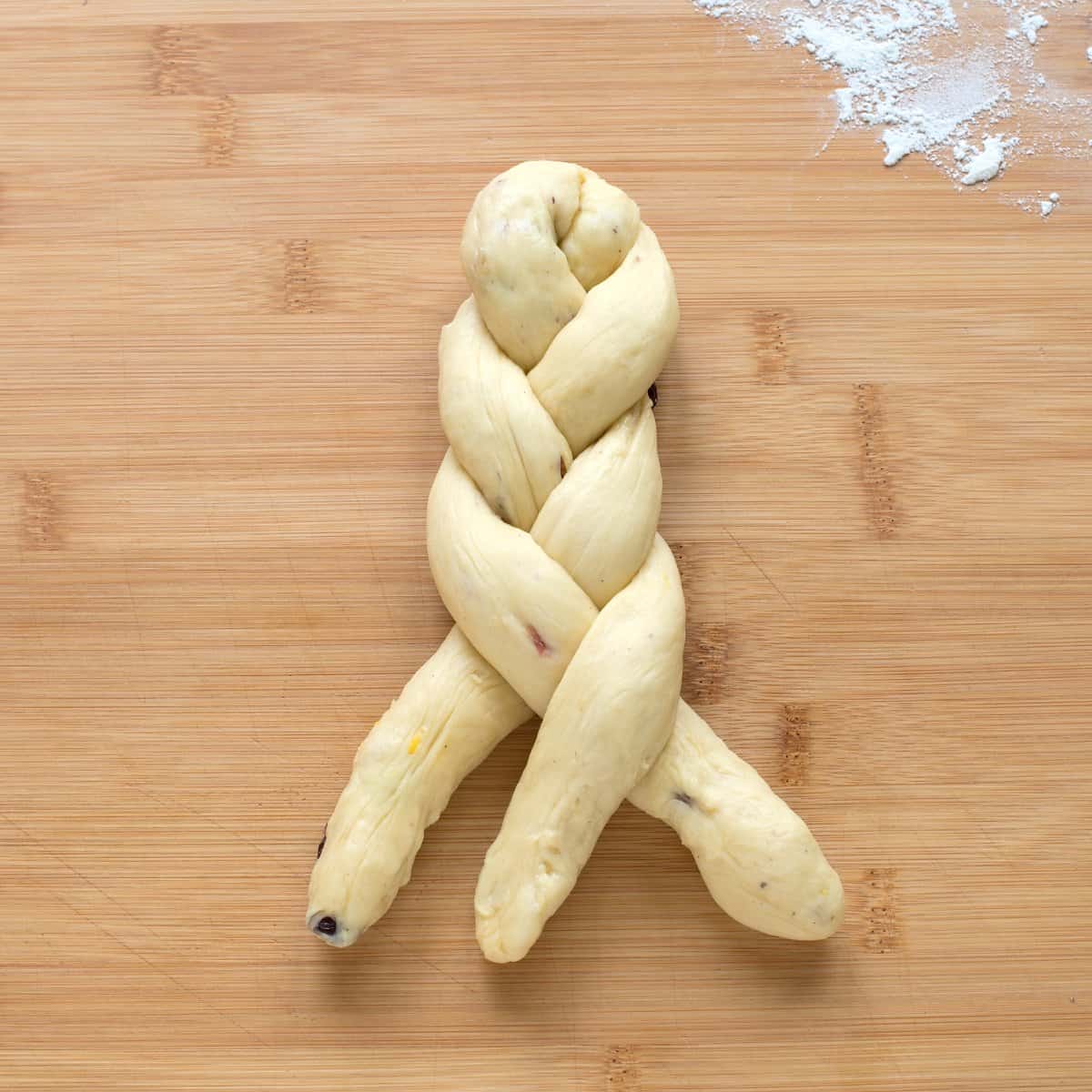 Three braided strands of dough for Czech houska bread.