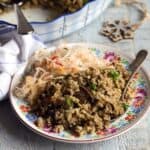 Mushroom barley casserolle served on a plate, with pickled kraut.