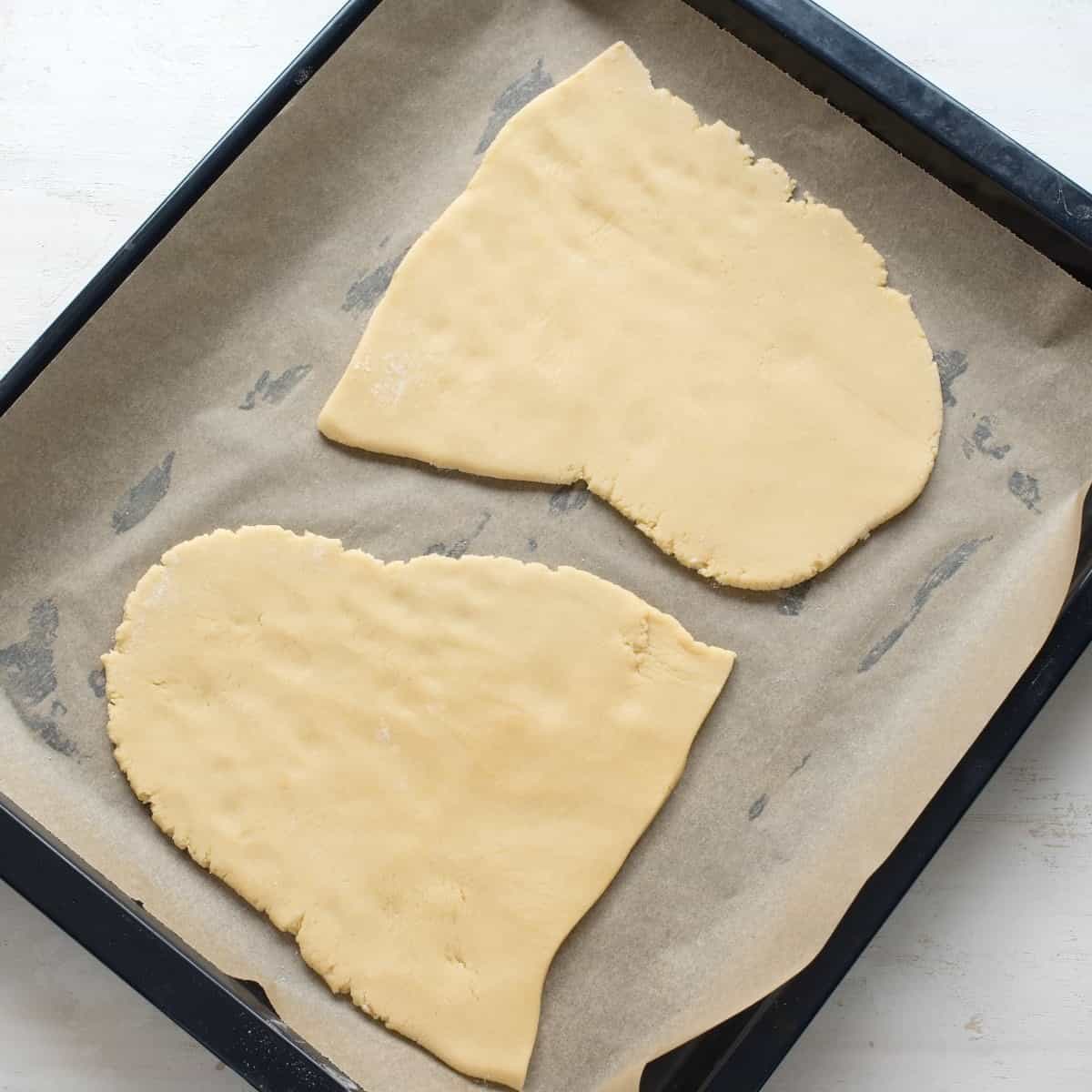 Two sheets of honey dough on a baking tray. Before baking.