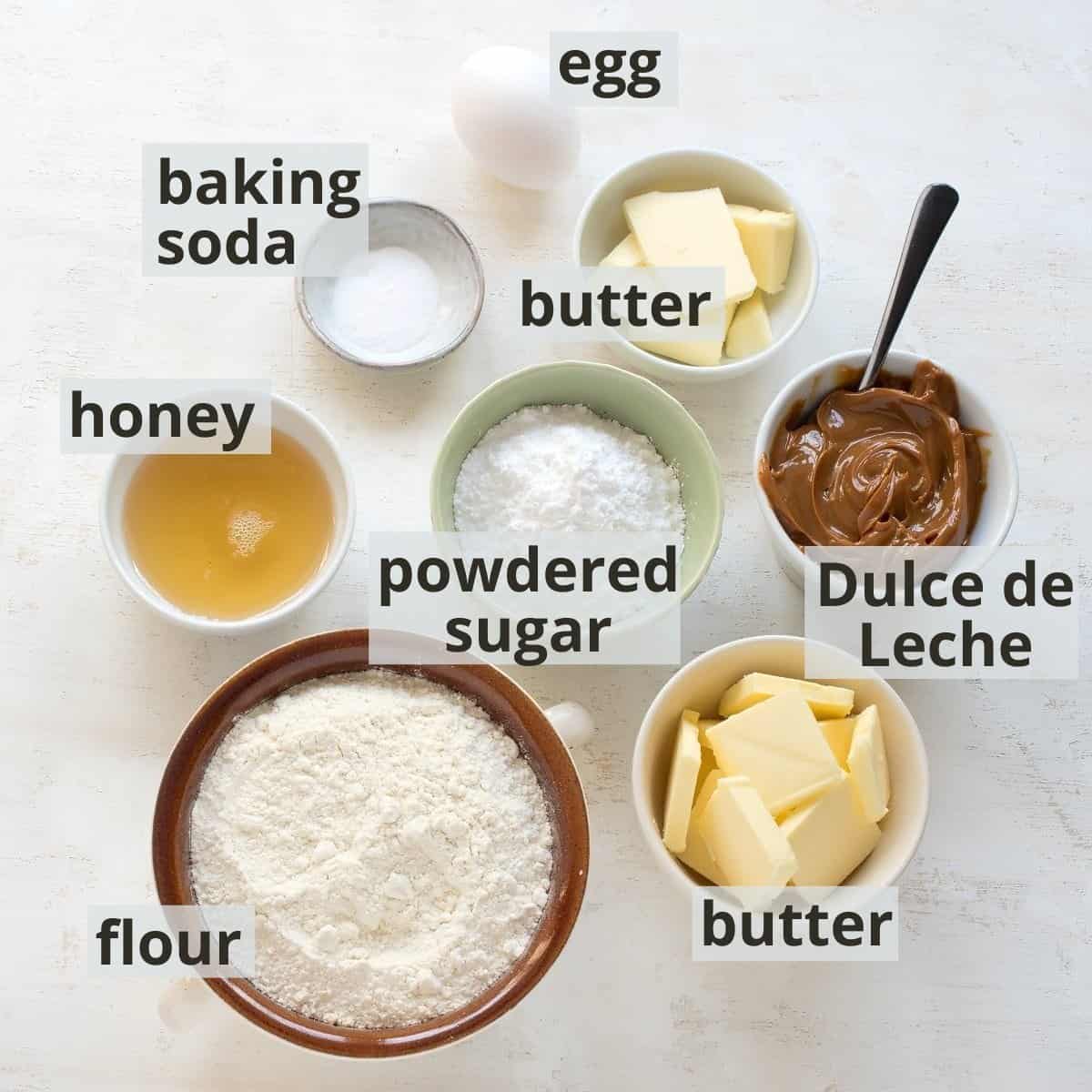 Ingredients labeled for preparing Czech Christmas honey ball cookies.