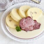 Czech horseradish sauce (křenová omáčka) served with dumplings and a slice of meat.